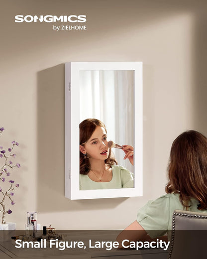 songmics lockable jewelry cabinet armoire with mirror, wall-mounted shown in use