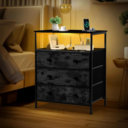 3-drawer led nightstand with charging station, black. shown in use