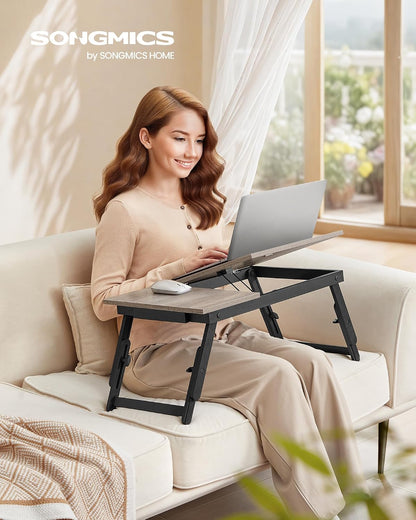 songmics bed laptop desk, folding bed table adjustable shown in use