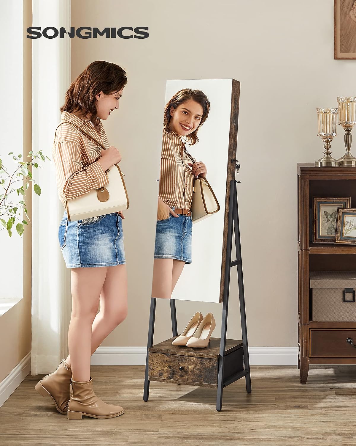 songmics led mirror jewelry cabinet armoire, freestanding lockable shown in use